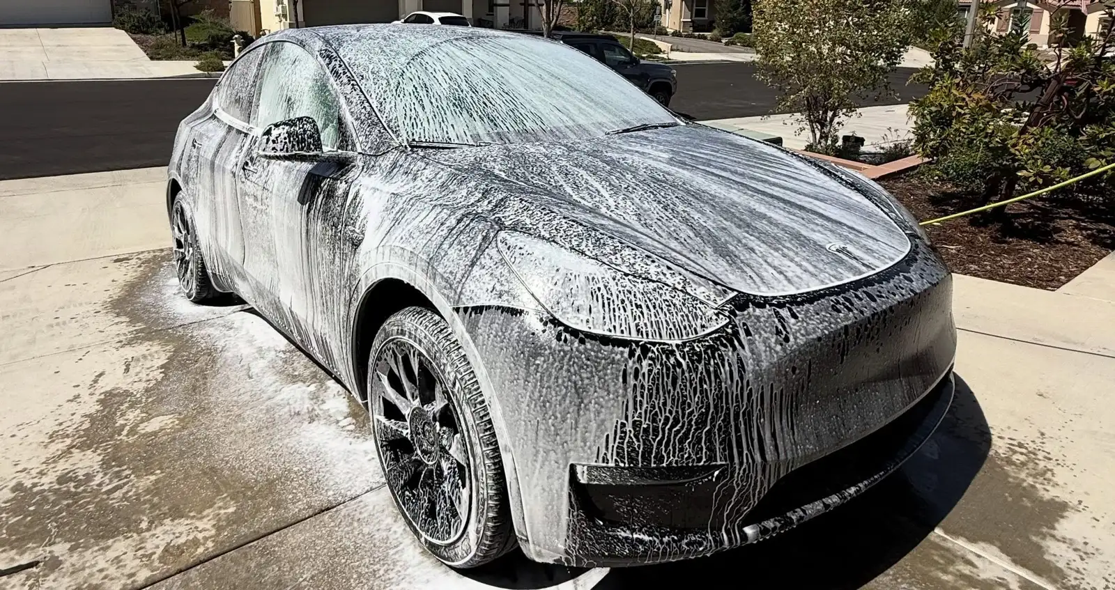 The same Tesla covered in foam during the hand wash