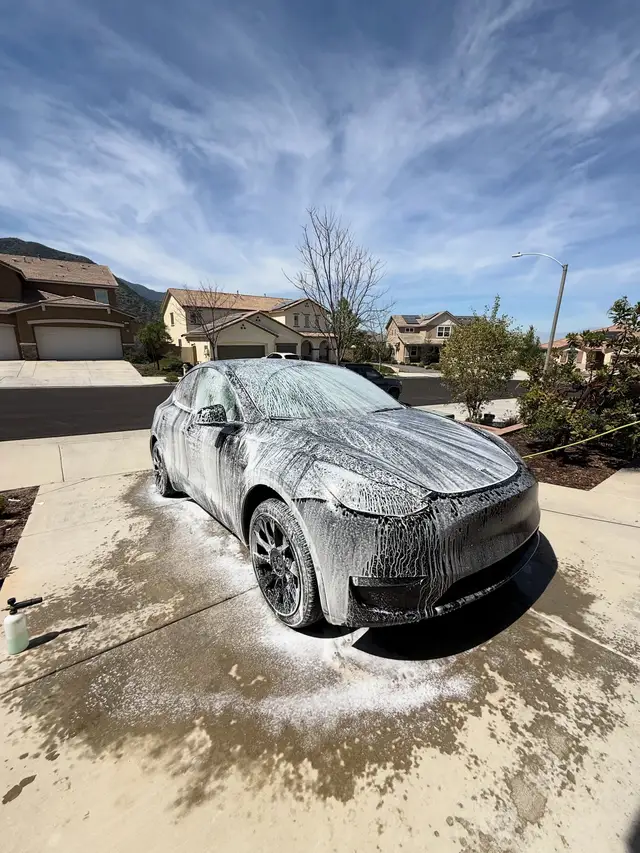 Foam bath on a Tesla in a driveway